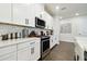 Modern kitchen with stainless steel appliances, white cabinets, and tiled backsplash at 6211 Sea Air Dr, Apollo Beach, FL 33572