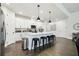 Bright kitchen with a large island, stainless steel appliances, and stylish pendant lighting at 6211 Sea Air Dr, Apollo Beach, FL 33572