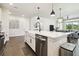 Kitchen with white cabinets, stainless steel appliances, and a view of the living and dining area at 6211 Sea Air Dr, Apollo Beach, FL 33572