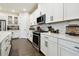 Beautiful kitchen with white cabinets, stainless steel appliances, and quartz countertops at 6211 Sea Air Dr, Apollo Beach, FL 33572