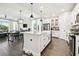 Bright, modern kitchen with white cabinets, stainless steel appliances, and a large island at 6211 Sea Air Dr, Apollo Beach, FL 33572