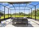 Inviting screened lanai offering comfortable seating and scenic views of the lush backyard at 6211 Sea Air Dr, Apollo Beach, FL 33572