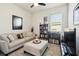 Comfortable living room with a beige sofa, ottoman, and a bookcase filled with reading material at 6211 Sea Air Dr, Apollo Beach, FL 33572