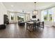 Spacious living room with large windows, gray sofa, and open to the dining area at 6211 Sea Air Dr, Apollo Beach, FL 33572