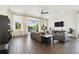 Living room featuring a gray sectional sofa, large windows, and open floor plan at 6211 Sea Air Dr, Apollo Beach, FL 33572