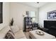Cozy living room area with comfortable seating, a flat-screen TV, and a bookcase at 6211 Sea Air Dr, Apollo Beach, FL 33572