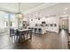 Open-concept living space with a kitchen, dining area, and living room, all with hardwood floors at 6211 Sea Air Dr, Apollo Beach, FL 33572