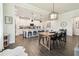 Open-concept living space with a kitchen, dining area, and living room, all with hardwood floors at 6211 Sea Air Dr, Apollo Beach, FL 33572