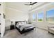 Bright main bedroom showcasing a tray ceiling, plush carpet, and a picturesque view from the large windows at 6211 Sea Air Dr, Apollo Beach, FL 33572