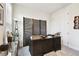 Well-lit home office with a dark wood desk, natural light, and stylish decor at 6211 Sea Air Dr, Apollo Beach, FL 33572