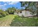 Spacious backyard with lush green lawn and mature trees at 6709 Peachtree Dr, Temple Terrace, FL 33617