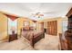 Spacious bedroom with a ceiling fan, carpet, and matching wood furniture at 6709 Peachtree Dr, Temple Terrace, FL 33617