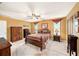 Bedroom with carpet, ceiling fan, and warm tones at 6709 Peachtree Dr, Temple Terrace, FL 33617