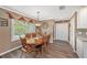 Charming dining room with an oval table and natural light from the window at 6709 Peachtree Dr, Temple Terrace, FL 33617