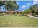 Charming home with a well-manicured lawn and mature landscaping, creating great curb appeal at 6709 Peachtree Dr, Temple Terrace, FL 33617