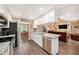 Bright kitchen featuring modern stainless steel appliances, granite counters, and white cabinetry at 6709 Peachtree Dr, Temple Terrace, FL 33617