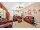Open-concept living room featuring wood flooring, comfortable seating and a view into the kitchen at 6709 Peachtree Dr, Temple Terrace, FL 33617