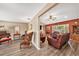 Open-concept living room featuring wood flooring, comfortable seating and a warm color palette at 6709 Peachtree Dr, Temple Terrace, FL 33617
