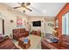 Comfortable living room with a ceiling fan, ample seating and rustic decor at 6709 Peachtree Dr, Temple Terrace, FL 33617