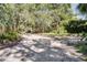 Backyard with a unique playground structure with swings and a covered treehouse near a driveway at 6924 Valrie Ln, Riverview, FL 33569