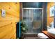 A modern bathroom boasts wood paneling, vessel sink, and glass shower enclosure for a spa-like experience at 6924 Valrie Ln, Riverview, FL 33569