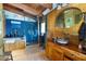 Unique bathroom featuring blue tile, wooden accents, glass shower, and an artistic vanity with custom vessel sink at 6924 Valrie Ln, Riverview, FL 33569