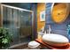 A unique bathroom features wood paneling, a vessel sink, and a glass-enclosed shower, creating a stylish space at 6924 Valrie Ln, Riverview, FL 33569