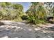 The driveway has a unique playground structure and is surrounded by trees and foliage at 6924 Valrie Ln, Riverview, FL 33569