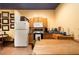 A functional kitchen with a stove, microwave, refrigerator, and wooden cabinetry provides a practical cooking space at 6924 Valrie Ln, Riverview, FL 33569