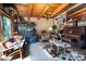 Eclectic living room with a wooden beamed ceiling, stone fireplace, exercise equipment, and unique furnishings at 6924 Valrie Ln, Riverview, FL 33569