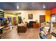 A large office with wood floors, brightly colored walls, a desk, and a window offers a creative workspace at 6924 Valrie Ln, Riverview, FL 33569