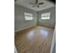 Bedroom featuring two windows, wood floor, and a ceiling fan at 7001 60Th N St, Pinellas Park, FL 33781