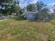 View of home featuring lawn area and attractive tropical trees at 7001 60Th N St, Pinellas Park, FL 33781