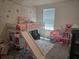 This adorable bedroom features a loft bed with a slide and carpet floors at 7575 Sail Clover Ln, Zephyrhills, FL 33540