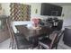 Cozy dining area with dark wood table and chairs, decorative wall art, and natural light at 7575 Sail Clover Ln, Zephyrhills, FL 33540
