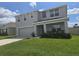 Charming two-story home with well-maintained lawn and a two car garage at 7575 Sail Clover Ln, Zephyrhills, FL 33540