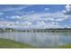 Scenic lake view showcasing the tranquil waterfront lifestyle and beautiful homes in the community at 7575 Sail Clover Ln, Zephyrhills, FL 33540