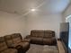 Spacious living room featuring comfortable couches and a television at 7575 Sail Clover Ln, Zephyrhills, FL 33540
