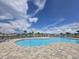 Community pool area with lounge chairs and paved deck offers a relaxing outdoor experience at 7575 Sail Clover Ln, Zephyrhills, FL 33540