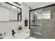 Sleek bathroom with glass shower and black fixtures at 7835 Wallaba Ln, New Port Richey, FL 34653
