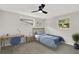 Cozy bedroom with a comfortable bed, desk, and lots of natural light at 7835 Wallaba Ln, New Port Richey, FL 34653