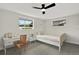 Well-lit bedroom featuring a desk, ceiling fan, and big windows at 7835 Wallaba Ln, New Port Richey, FL 34653