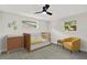 Bright Bedroom with a crib, dresser, and cozy yellow accent chair at 7835 Wallaba Ln, New Port Richey, FL 34653