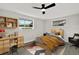 Stylized bedroom with desk, ceiling fan, and abundant natural light at 7835 Wallaba Ln, New Port Richey, FL 34653