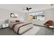 The light filled bedroom features a ceiling fan, large window, and neutral colors at 7835 Wallaba Ln, New Port Richey, FL 34653