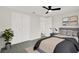 Well-lit bedroom features double closets, a ceiling fan, and neutral decor at 7835 Wallaba Ln, New Port Richey, FL 34653