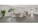 Bright dining area features gray laminate floors and a dining table with six chairs at 7835 Wallaba Ln, New Port Richey, FL 34653