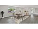 The dining area offers large windows, a modern light fixture, and new floors at 7835 Wallaba Ln, New Port Richey, FL 34653