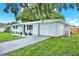 Charming single-story home with a well-manicured lawn and a driveway at 7835 Wallaba Ln, New Port Richey, FL 34653
