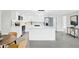 Modern kitchen features a white island, stainless appliances, and wood-look flooring at 7835 Wallaba Ln, New Port Richey, FL 34653